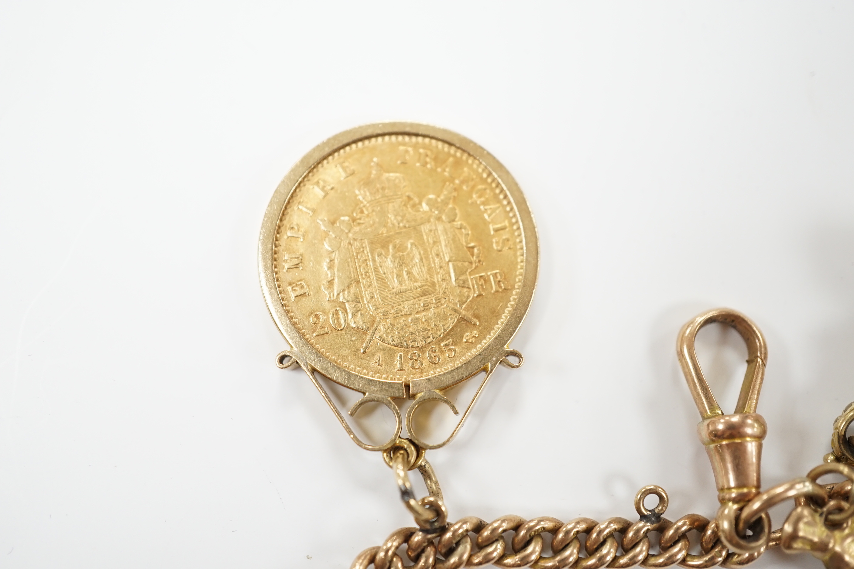 A 9ct gold curblink chain hung with fifteen assorted charms including a 1906 sovereign and an 1865 20 francs coin, gross 80.8 grams